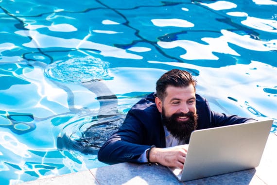 man-on-laptop-in-swimming-pool-working-on-his-business-online-presence