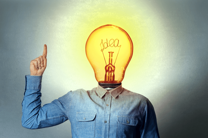 person pointing up with a light bulb with the text idea as a head after coming up with a memorable company name